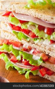 sandwich with ham tomato and lettuce