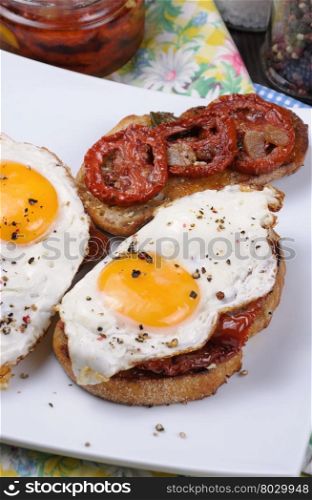 Sandwich with slices of dried tomatoes and egg flavored spices