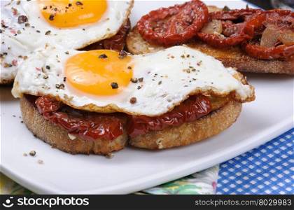 Sandwich with slices of dried tomatoes and egg flavored spices closeup