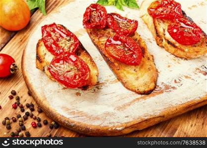 Sandwich with sun-dried tomatoes.Italian bruschetta.Delicious dried tomatoes. Bruschetta with sun dried tomatoes