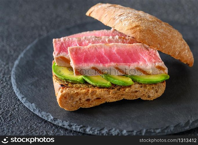 Sandwich with tuna and avocado close-up