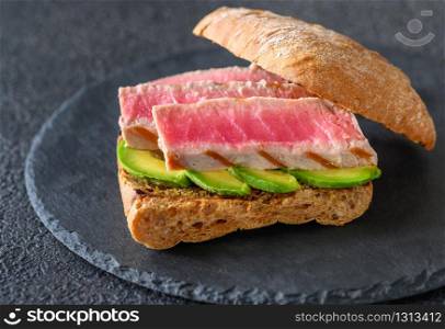 Sandwich with tuna and avocado close-up