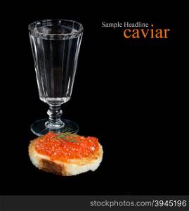 Sandwiche with fish eggs and glass of vodka isolated on black background; with space for text