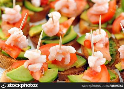 sandwiches garnish with shrimps, avokado and lettuce close up, snack