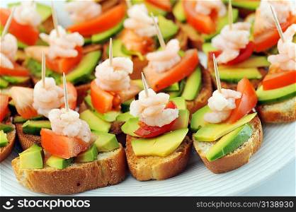 sandwiches garnish with shrimps, avokado and lettuce close up, snack