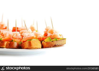 sandwiches garnish with shrimps, avokado and lettuce on plate, snack