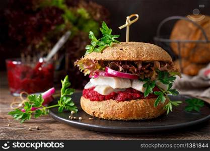 Sandwiches, hamburgers with homemade wholemeal bread, herring, puree of beetroot, red onion, parsley and fresh lettuce salad