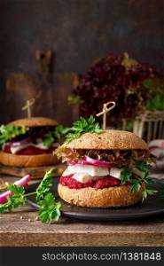 Sandwiches, hamburgers with homemade wholemeal bread, herring, puree of beetroot, red onion, parsley and fresh lettuce salad