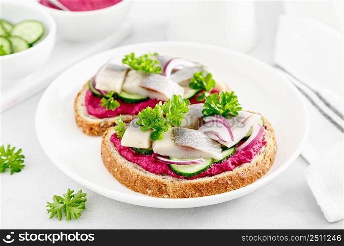 Sandwiches, toasts with salted herring and beetroot pate