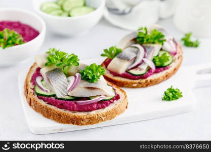 Sandwiches, toasts with salted herring and beetroot pate