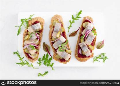 Sandwiches, toasts with salted herring and beetroot pate, top view