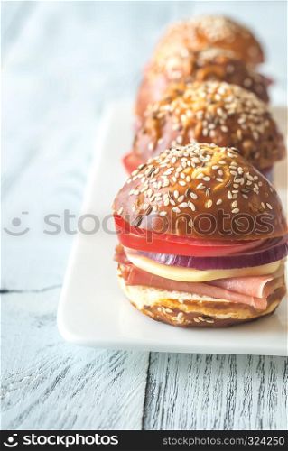 Sandwiches with cheese and ham on the plate
