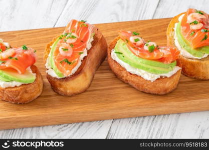 Sandwiches with cream cheese, avocado and salmon