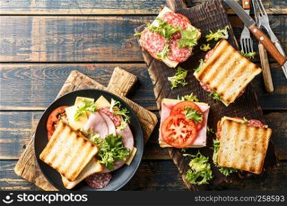 sandwiches with grilled toast ham salami cheese tomatoes and lettuce