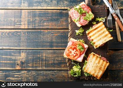 sandwiches with grilled toast ham salami cheese tomatoes and lettuce