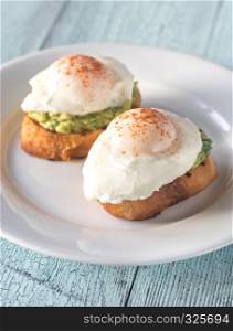 Sandwiches with guacamole and poached eggs