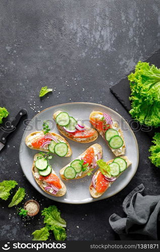 Sandwiches with homemade ciabatta bread, salted salmon fish, feta cheese, cucumber, onion and fresh lettuce salad