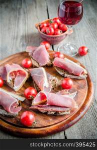 Sandwiches with italian ham on the wooden board