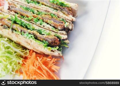 sandwiches with meat and vegetables on plate