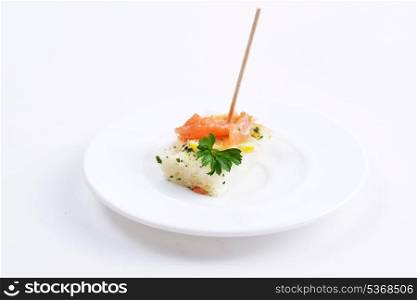 Sandwiches with red fish and greens on wooden chopsticks