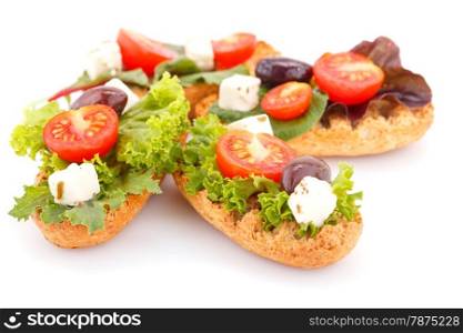 Sandwiches with rusks, vegetables, olives and feta cheese isolated on white background.