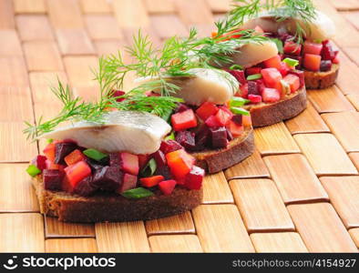 Sandwiches with rye bread, herring and vegetables