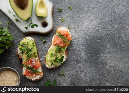 Sandwiches with salted salmon,  avocado and microgreens.  Healthy food.