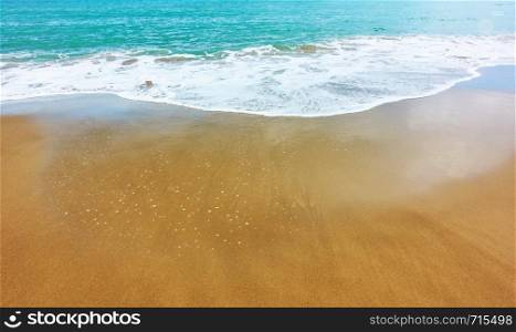 Sandy beach and soft sea surf - - background with largre space for your own text