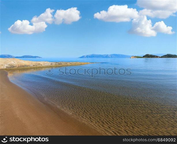 Sandy beach morning landscape (Narta Lagoon, Vlore, Albania). Deep blue sky with some cumulus clouds.