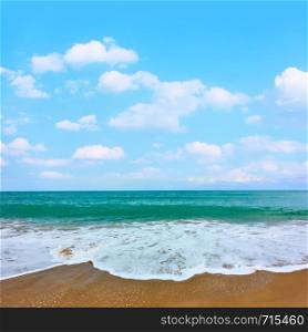 Sandy beach of seaside resort and waves with white foam - Background with space for your own text