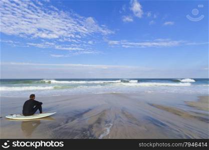 Sandy beach with a surfer.. View of a sandy beach with a surfer.