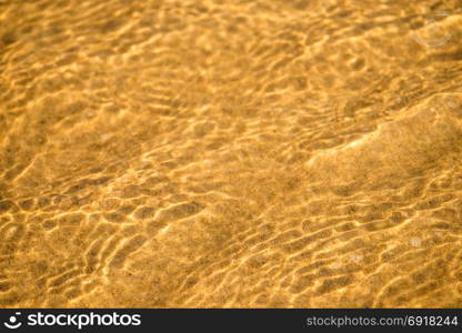 Sandy beach with shallow water of the surf