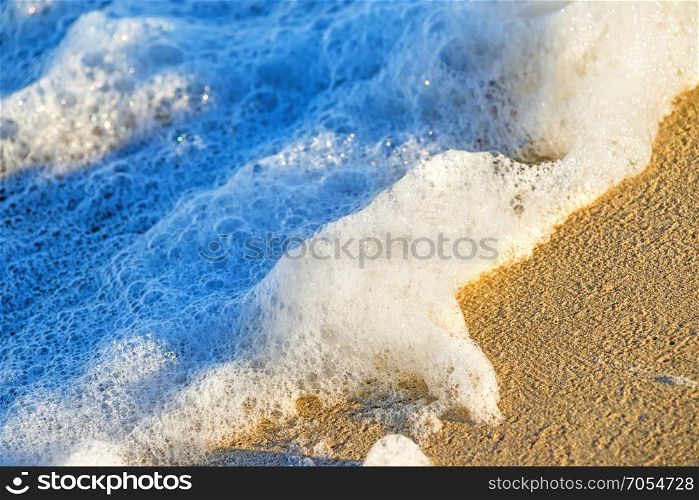 sandy beach with spray of the surf
