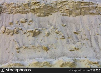 Sandy cascades of a sandy mountain, background and texture of yellow sand.. Sandy mountain background and texture of yellow sand