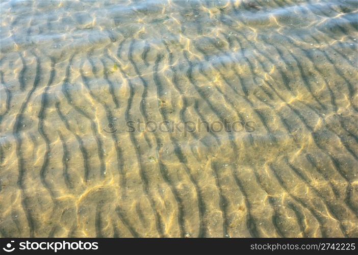 Sandy sea bottom in through water