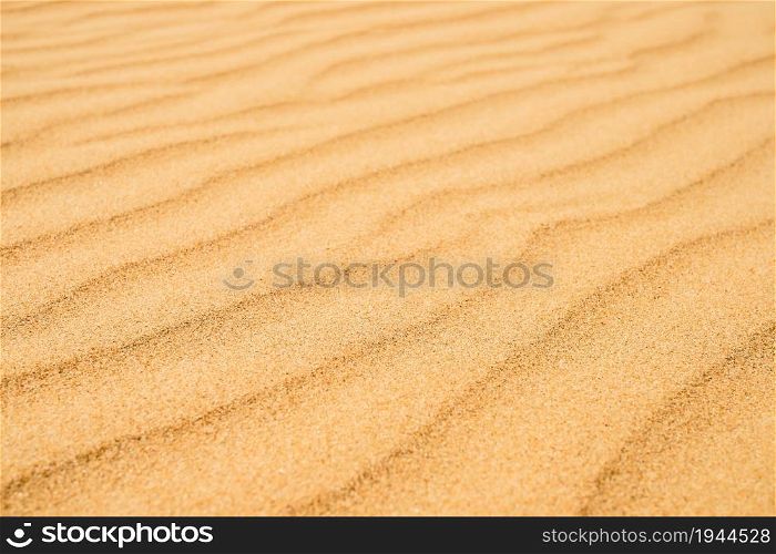 Sandy texture on the beach, black sea coast. Top view of abstract beach sand dunes for summer banner background.