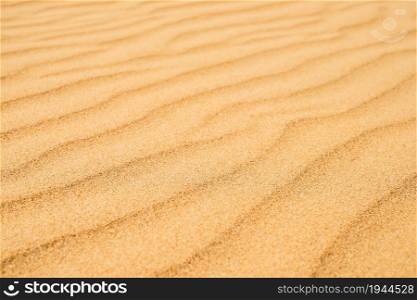 Sandy texture on the beach, black sea coast. Top view of abstract beach sand dunes for summer banner background.