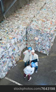 sanitation workers working in recycling plant