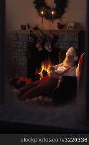 Santa Claus Asleep Next To Fireplace