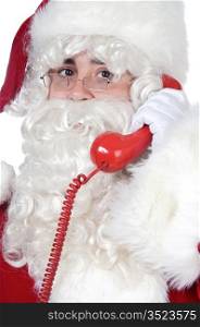 Santa Claus at the phone over white background