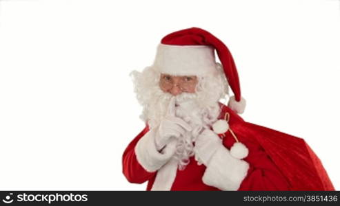 Santa Claus carrying his bag, looks at the camera and winks, white