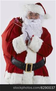 Santa Claus Carrying Sack Filled With Gifts