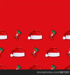 Santa Claus christmas red hat and christmas sock isolated on red background. Christmas seamless pattern. Copy space.