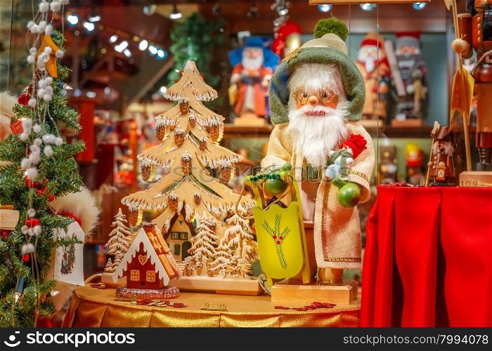 Santa Claus, Christmas tree and toys at a Christmas souvenir market shop, decorated and illuminated in Bruges, Belgium