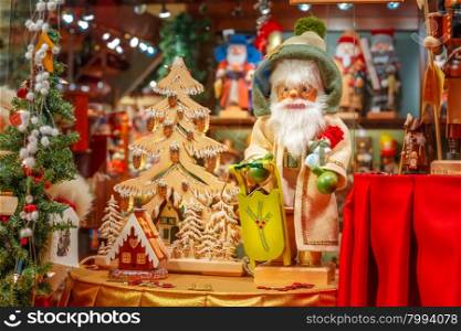 Santa Claus, Christmas tree and toys at a Christmas souvenir market shop, decorated and illuminated in Bruges, Belgium