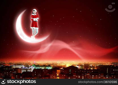 Santa Claus girl on the moon above a city at night