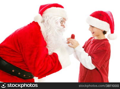 Santa Claus gives a Christmas lollipop to a cute little boy. Isolated on white.