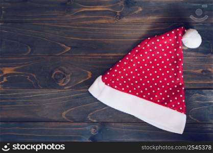 Santa claus hat on wood background with copy space