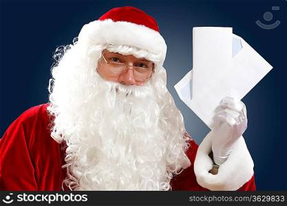 Santa Claus holding and reading a letter to him