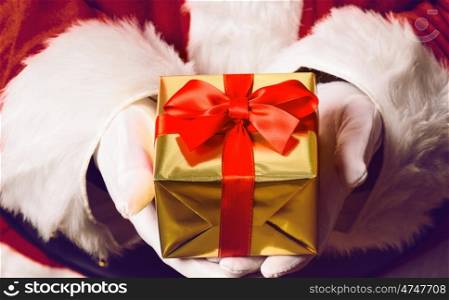 Santa Claus holding gift. Santa Claus holding gift box in both hands